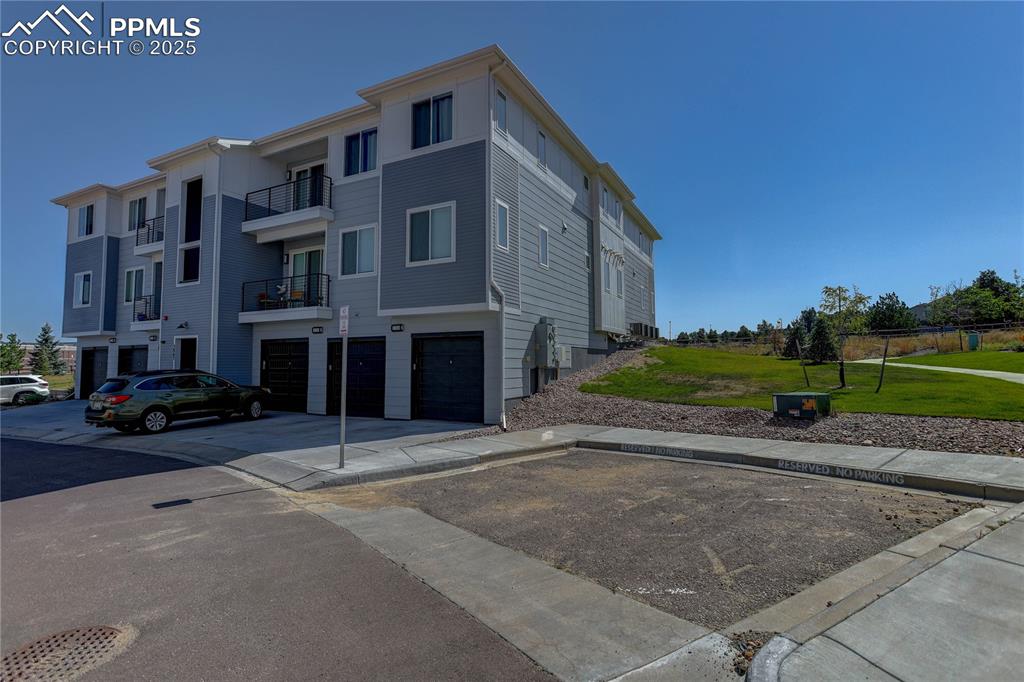 3865 Presidio Point, Unit 101 Colorado Springs, CO 80920 - Photo 19 of 20 a view of a street with a building in the background