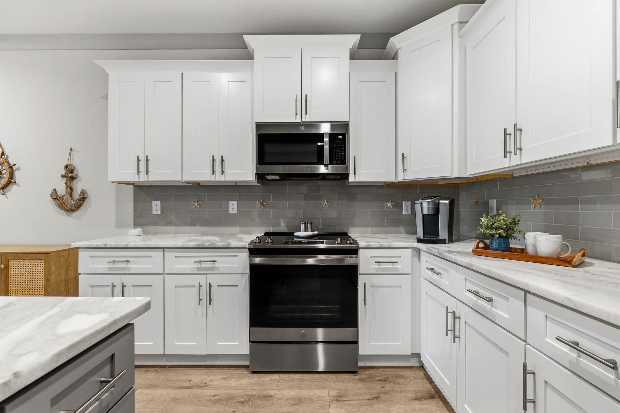 45 Golden Bell Court, Unit 45C Inlet Beach, FL 32461 - Photo 11 of 43 a kitchen with white cabinets and stainless steel appliances