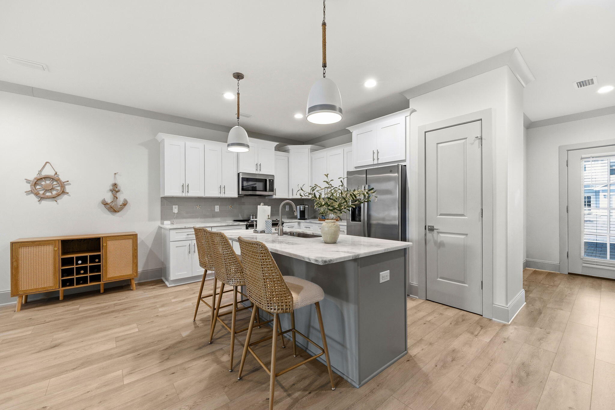 45 Golden Bell Court, Unit 45C Inlet Beach, FL 32461 - Photo 10 of 43 a kitchen with kitchen island granite countertop a stove a refrigerator a sink a dining table and chairs with wooden floor