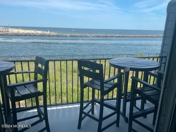 a view of a chairs and table in the balcony