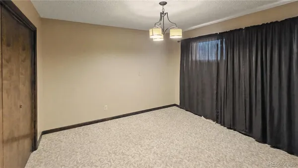 a view of a big room with wooden floor and windows in a room
