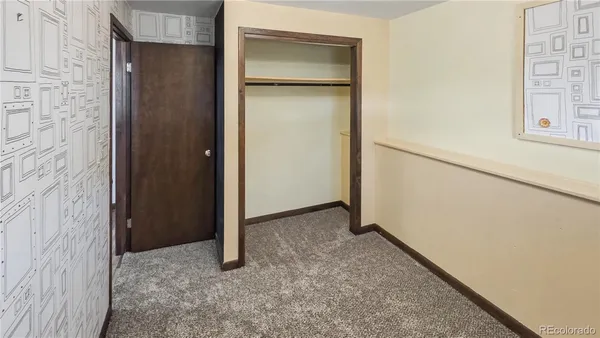 a white toilet sitting next to a bathroom sink and vanity