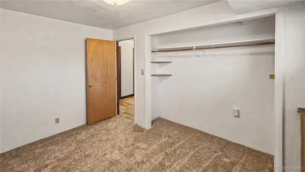 a view of an empty room with stairs