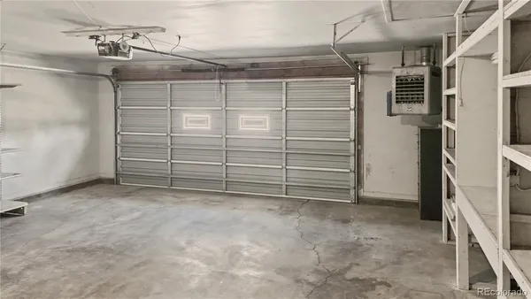 a view of an empty room with cabinet and a window