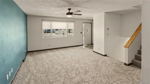 an empty room with windows and entrance