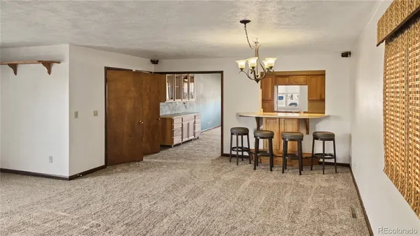 a view of a dining room with furniture and window