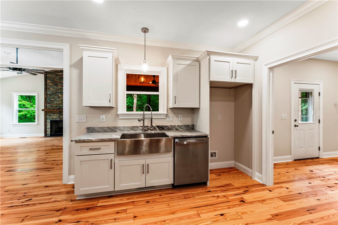 110 Gabriel Way Pickens, SC 29671 - Photo 10 of 48 A sleek kitchen features a farmhouse sink and stainless steel appliances.