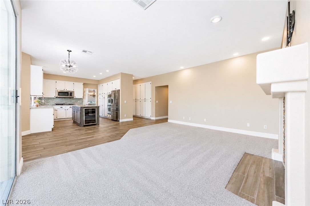 2504 Putting Green Drive Henderson, NV 89074 - Photo 18 of 56 This expansive open concept space features a well-appointed kitchen and comfortable living area with fireplace.