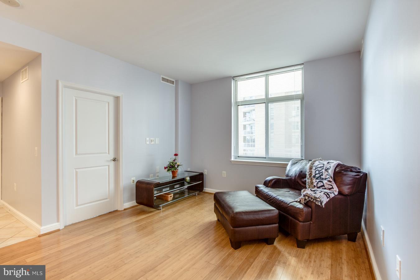 11990 Market Street, Unit 1308 Reston, VA 20190 - Photo 11 of 30 a living room with furniture and a window