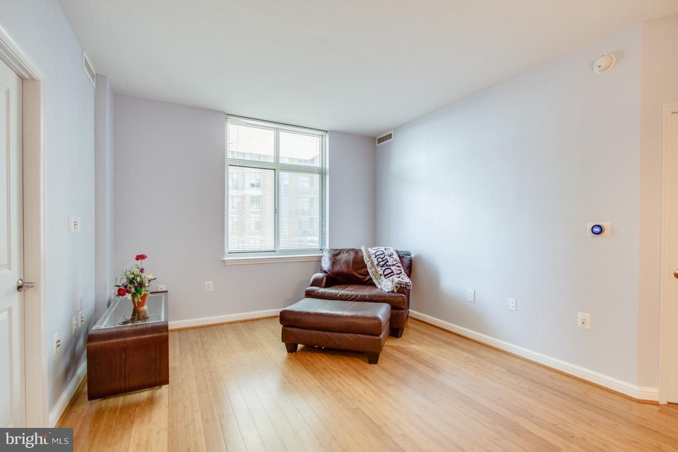 11990 Market Street, Unit 1308 Reston, VA 20190 - Photo 12 of 30 a living room with furniture and wooden floor