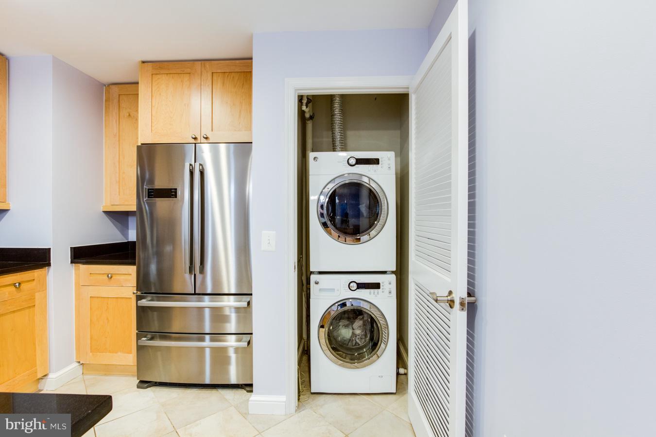 11990 Market Street, Unit 1308 Reston, VA 20190 - Photo 6 of 30 a view of a kitchen with washer and dryer