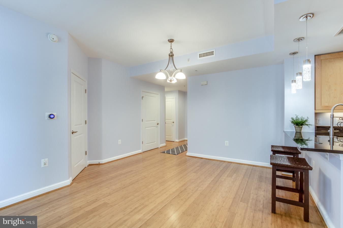 11990 Market Street, Unit 1308 Reston, VA 20190 - Photo 9 of 30 a view of a livingroom with wooden floor and furniture