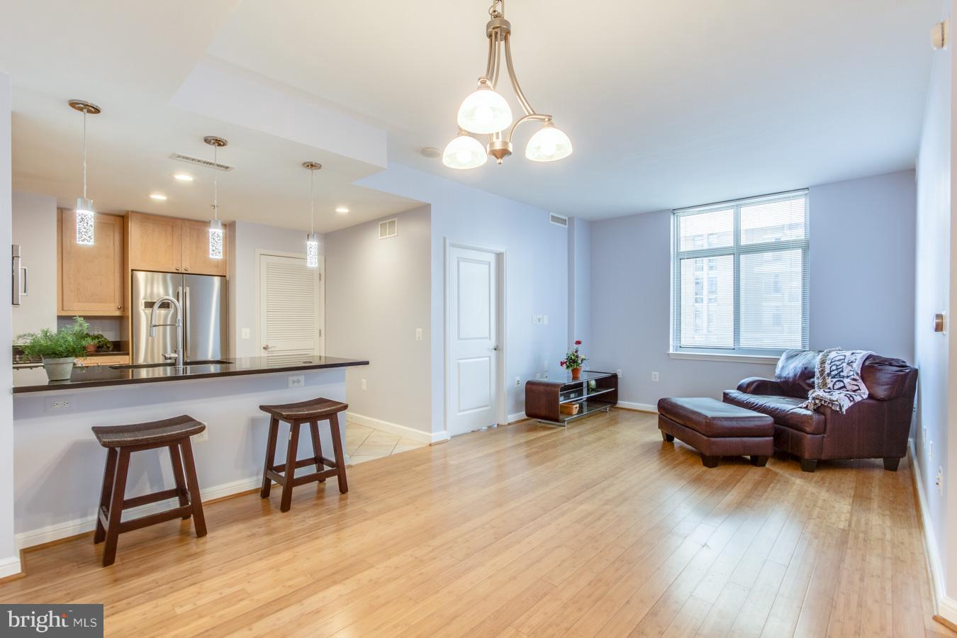 11990 Market Street, Unit 1308 Reston, VA 20190 - Photo 10 of 30 a living room with furniture and a wooden floor