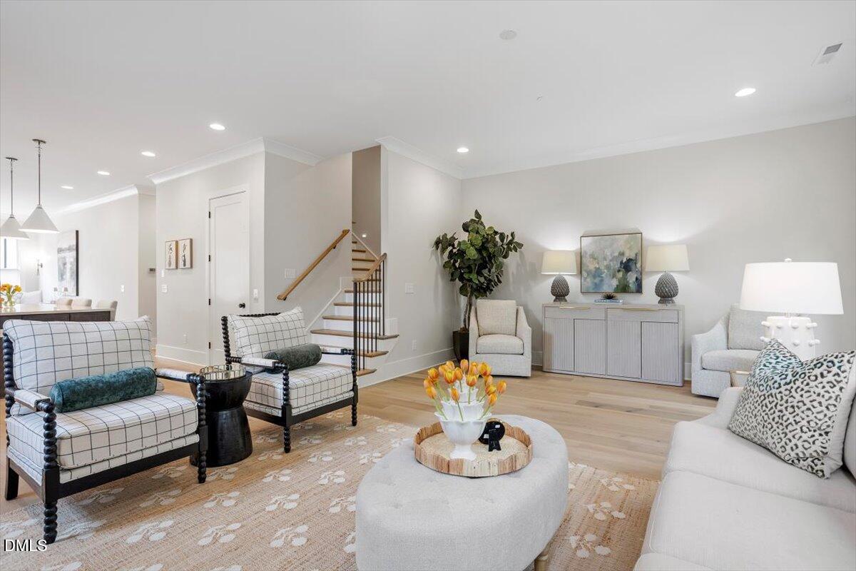 811 Maple Berry Lane, Unit 101 Raleigh, NC 27607 - Photo 19 of 45 a living room with furniture and wooden floor