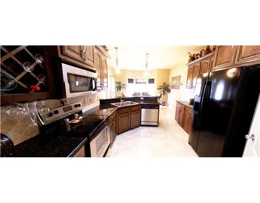 a kitchen with stainless steel appliances a sink stove and refrigerator