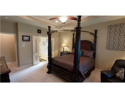 a bedroom with a bed window and a mirror