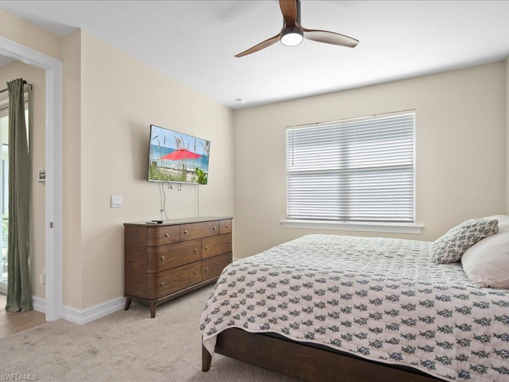1046 Enbrook Loop Naples, FL 34114 - Photo 15 of 43 Carpeted bedroom with ceiling fan