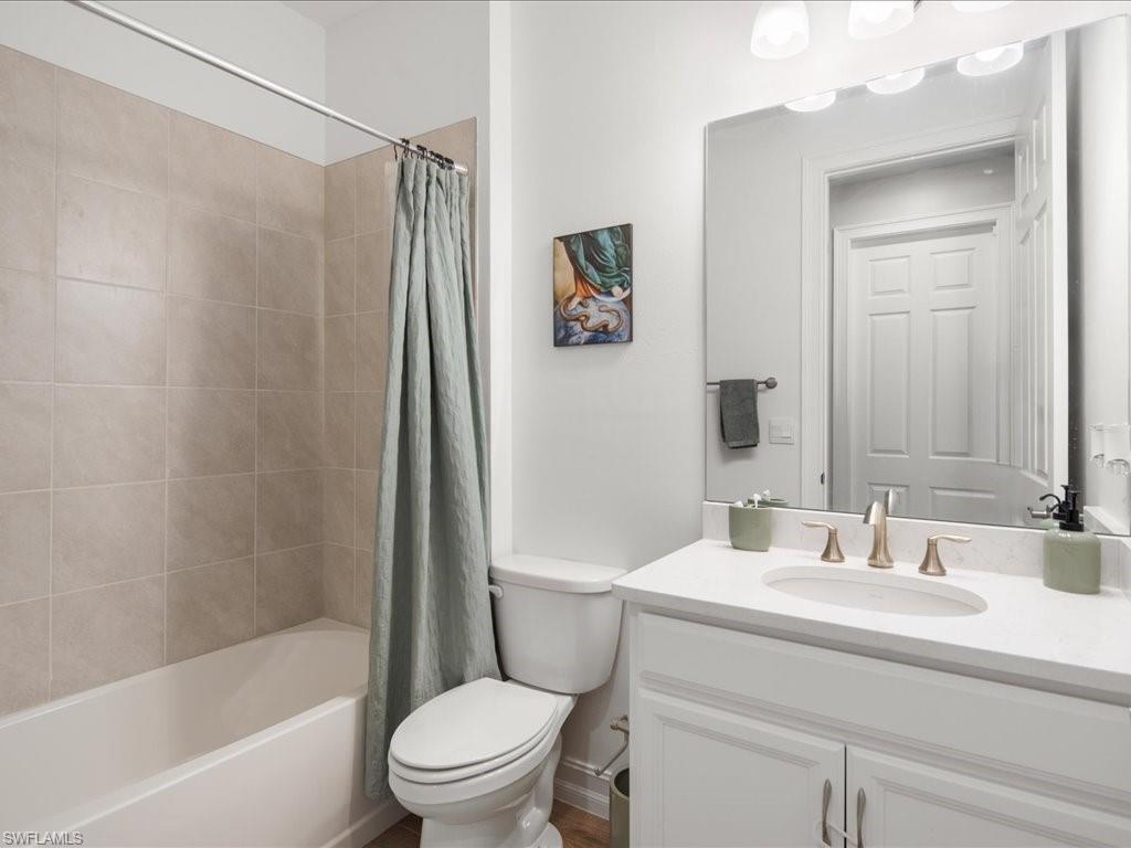 1046 Enbrook Loop Naples, FL 34114 - Photo 8 of 43 Full bathroom featuring vanity, toilet, and shower / bathtub combination with curtain