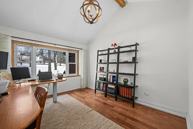 a view of a workspace with furniture and a window