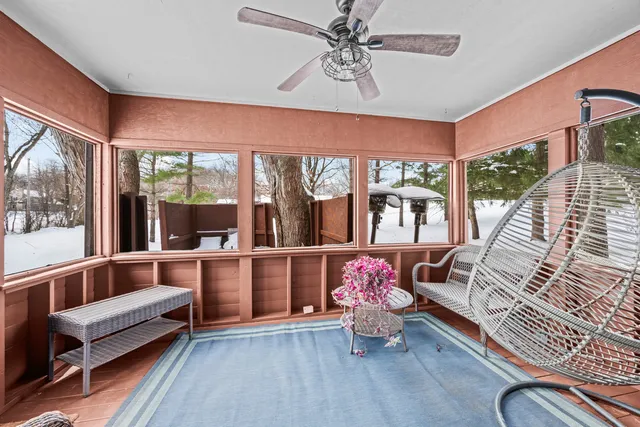 a view of a dinning tables and chairs in backyard of house