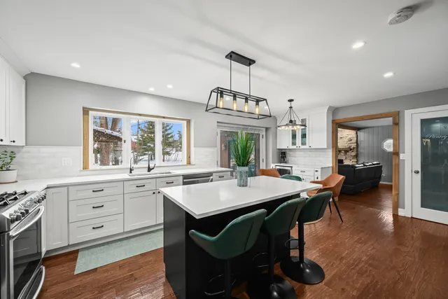 a very nice looking dining room with a table chairs and wooden floor