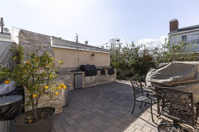 a view of backyard with outdoor seating and plants