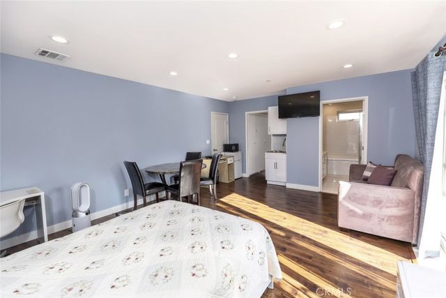 a living room with furniture a dining table and chairs