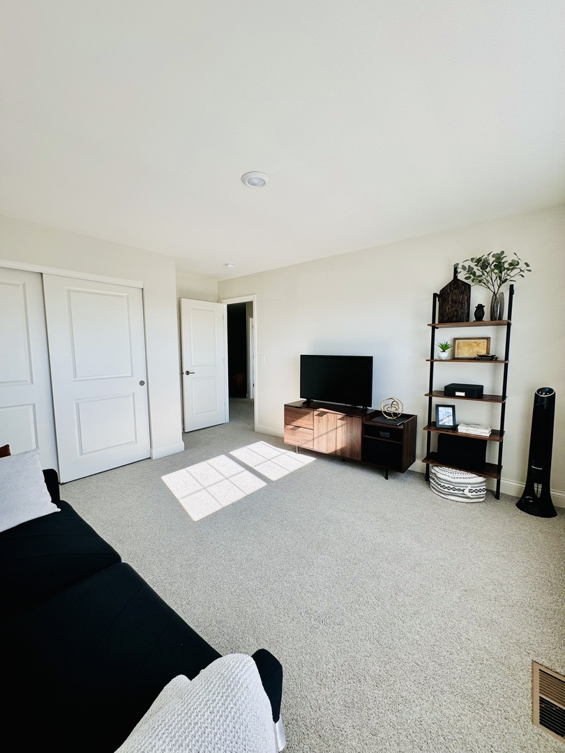 3626 Edelweiss Road Elgin, IL 60124 - Photo 25 of 28 a living room with furniture and a flat screen tv