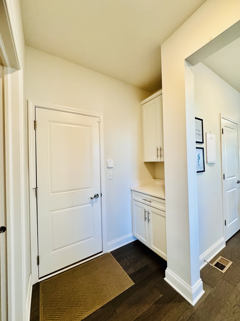 3626 Edelweiss Road Elgin, IL 60124 - Photo 9 of 28 a view of a kitchen with an empty space and wooden floor