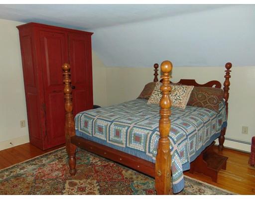 38 Richmond Road Freetown, MA 02702 - Photo 24 of 30 a bed sitting in a bedroom next to a wooden door