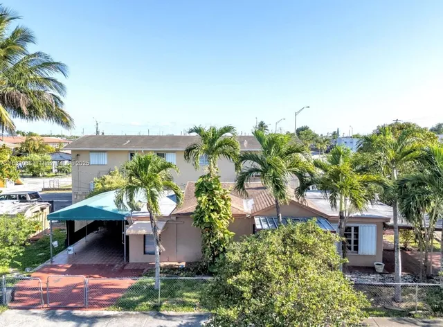 a view of a patio with table and chairs and potted plants