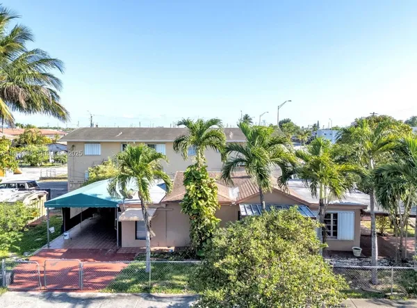 a view of a patio with table and chairs and potted plants