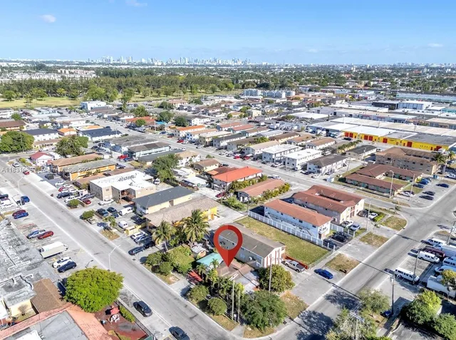 an aerial view of residential houses with outdoor space