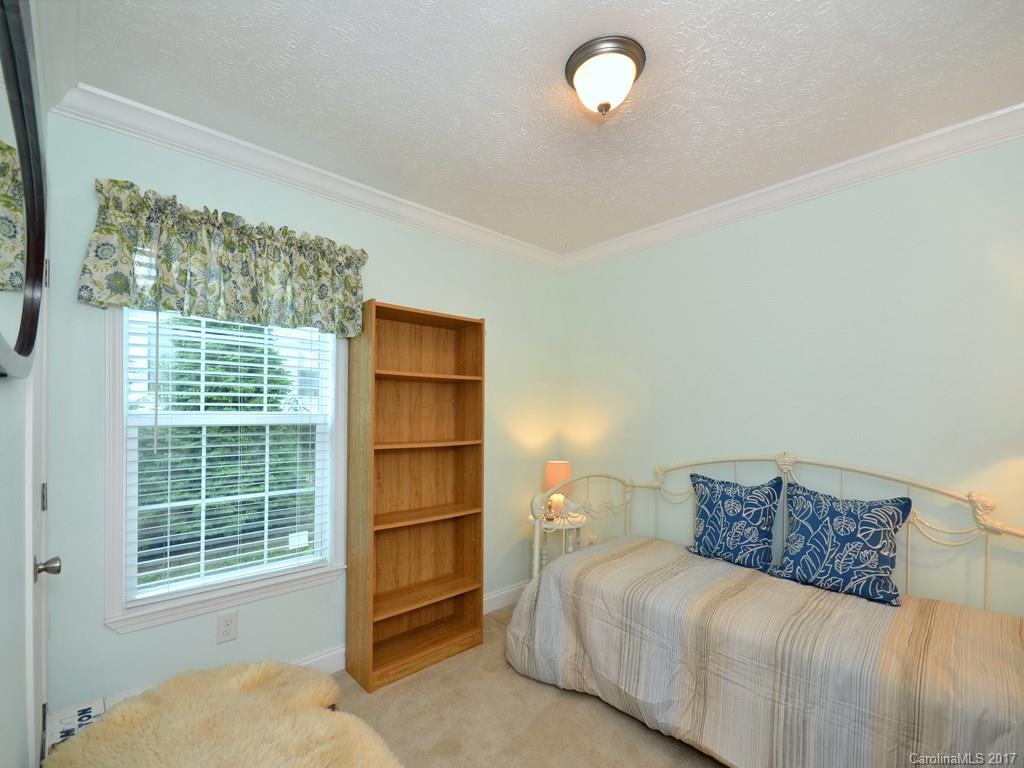 141 Ingram Loop Clyde, NC 28721 - Photo 12 of 16 a bedroom with a bed and a window