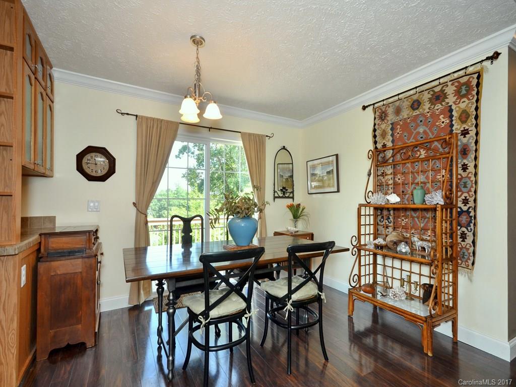 141 Ingram Loop Clyde, NC 28721 - Photo 8 of 16 a dining room with furniture a chandelier and wooden floor