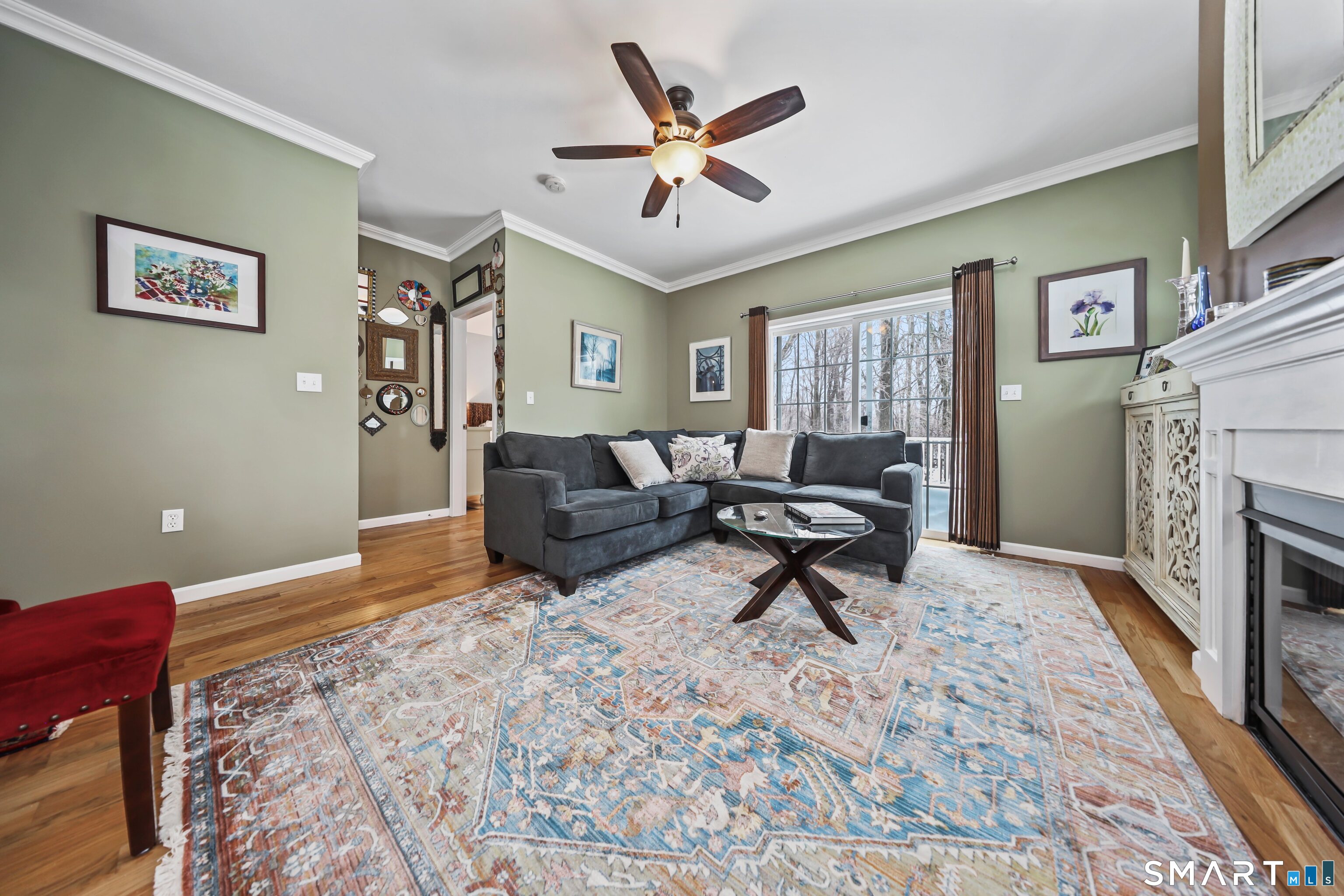101 Turtlebrook Lane, Unit 101 Bristol, CT 06010 - Photo 25 of 48 a living room with furniture a fireplace and a table