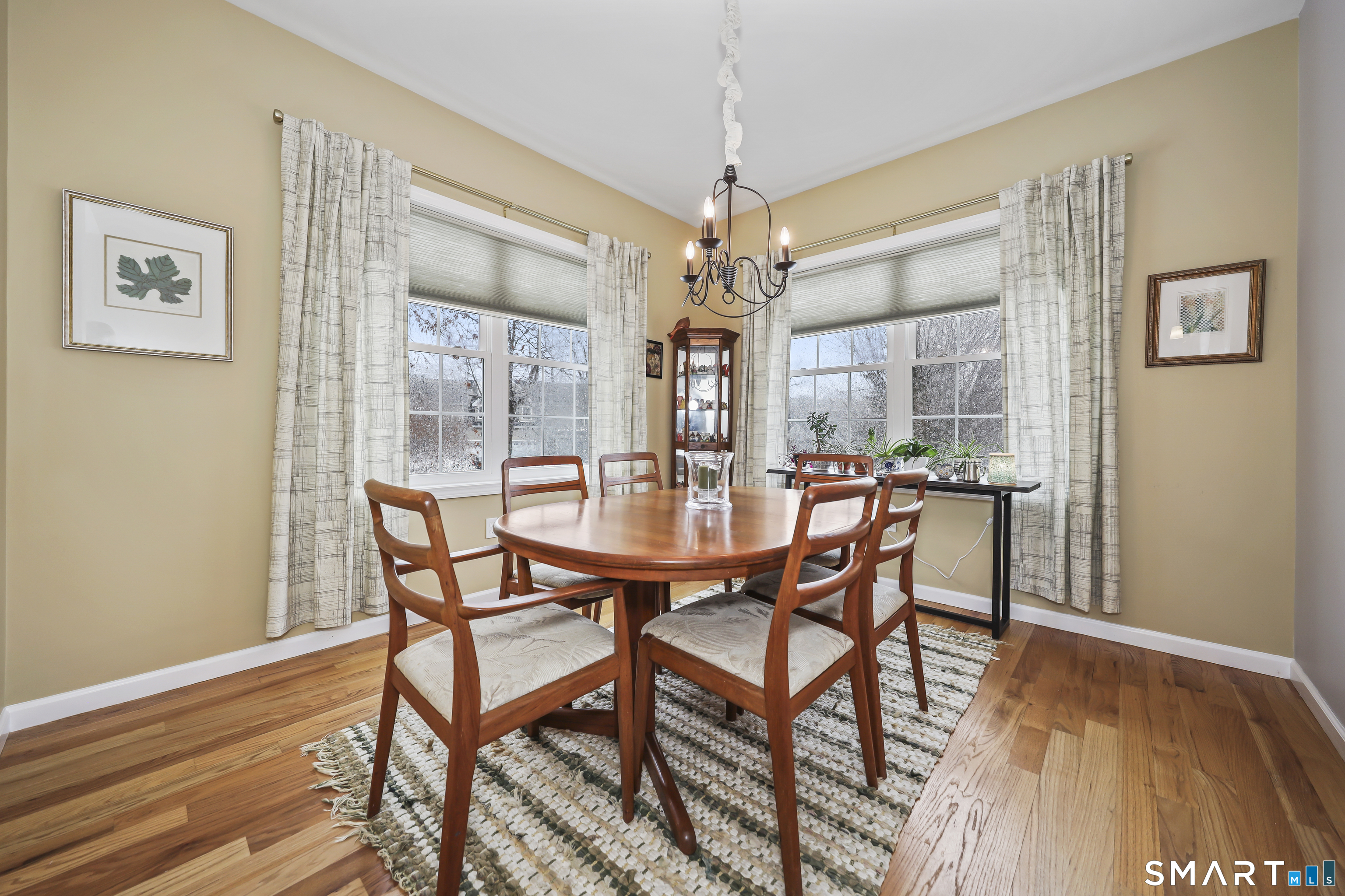 101 Turtlebrook Lane, Unit 101 Bristol, CT 06010 - Photo 26 of 48 a dining room with furniture a chandelier and wooden floor