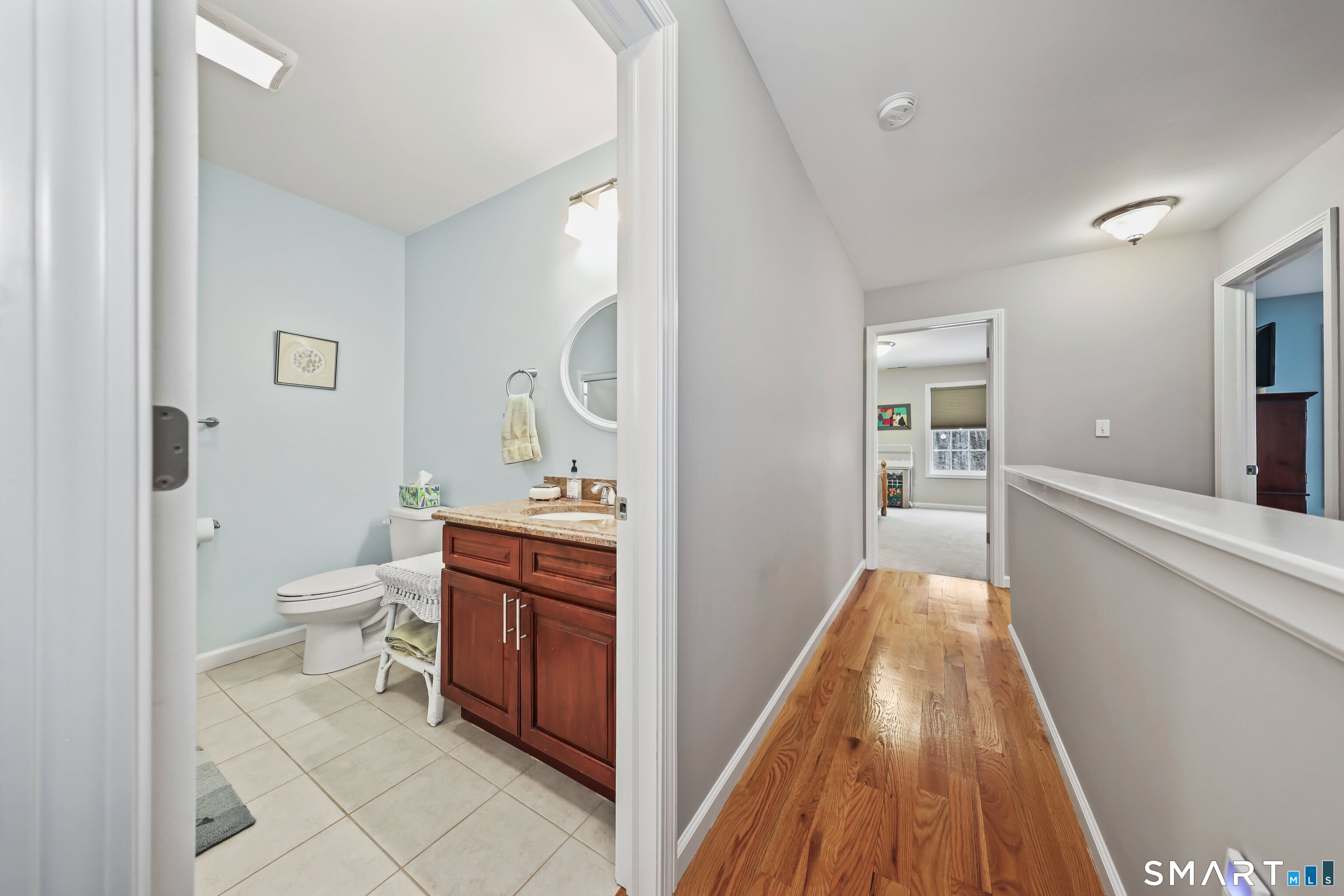 101 Turtlebrook Lane, Unit 101 Bristol, CT 06010 - Photo 38 of 48 a view of bathroom with a toilet a sink and a mirror