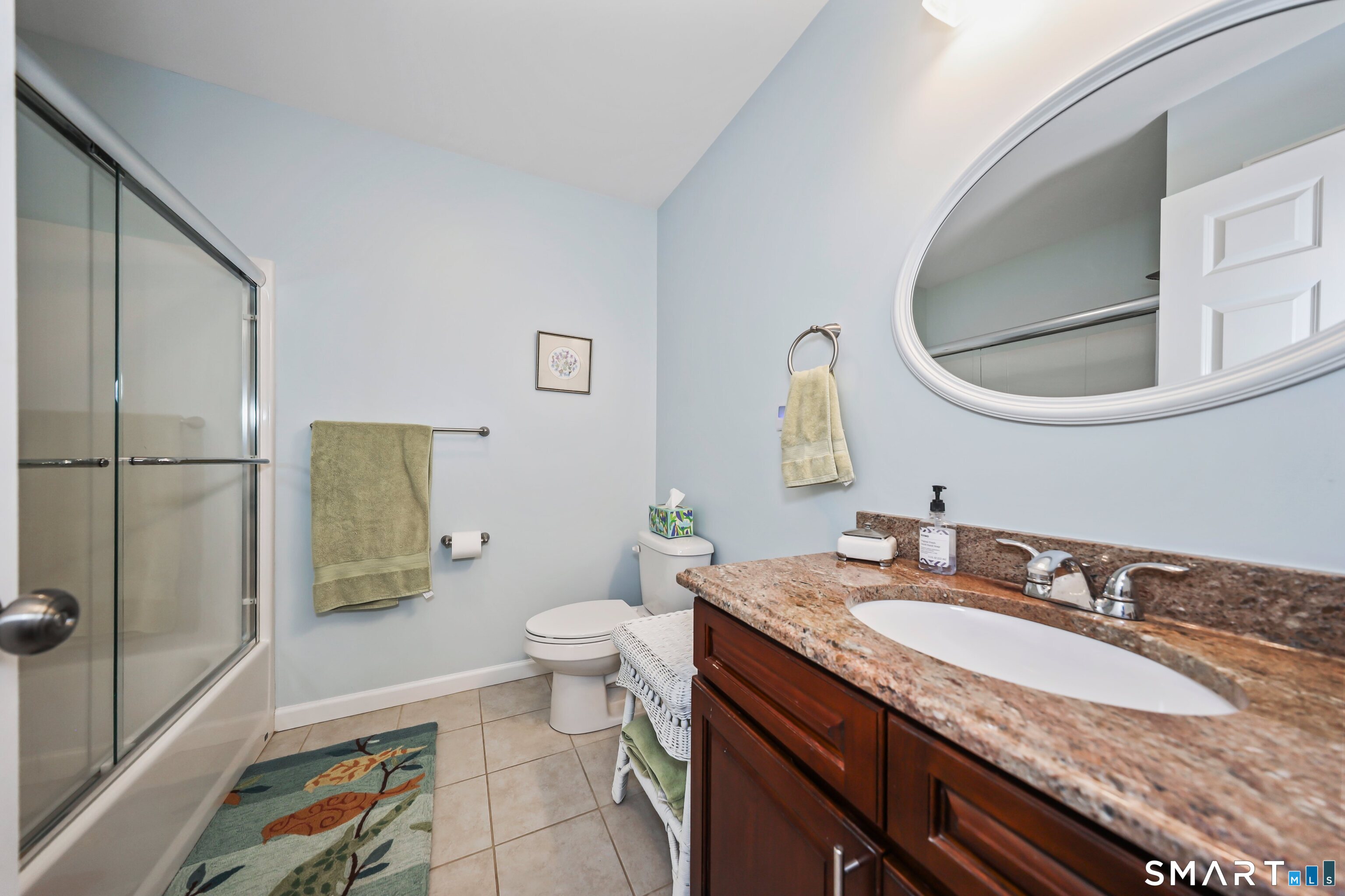 101 Turtlebrook Lane, Unit 101 Bristol, CT 06010 - Photo 39 of 48 a bathroom with a granite countertop sink and a mirror