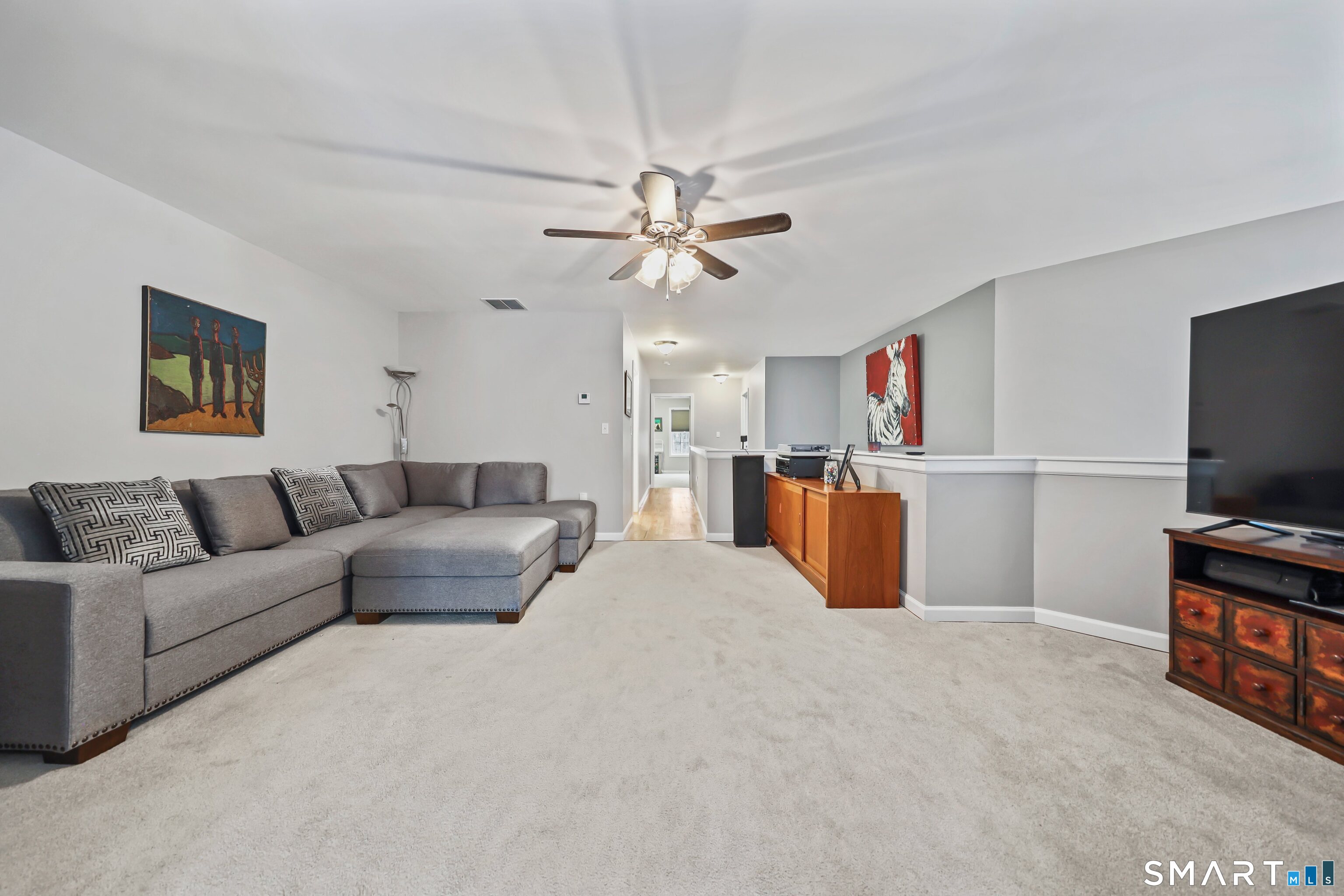 101 Turtlebrook Lane, Unit 101 Bristol, CT 06010 - Photo 41 of 48 a living room with furniture and a flat screen tv