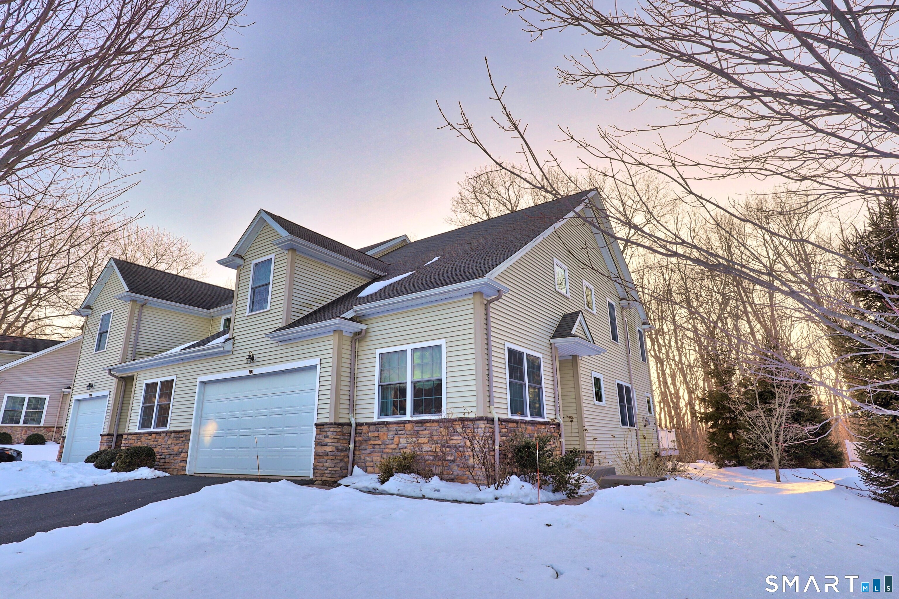 101 Turtlebrook Lane, Unit 101 Bristol, CT 06010 - Photo 45 of 48 a view of a white house with a yard covered with snow in front of house