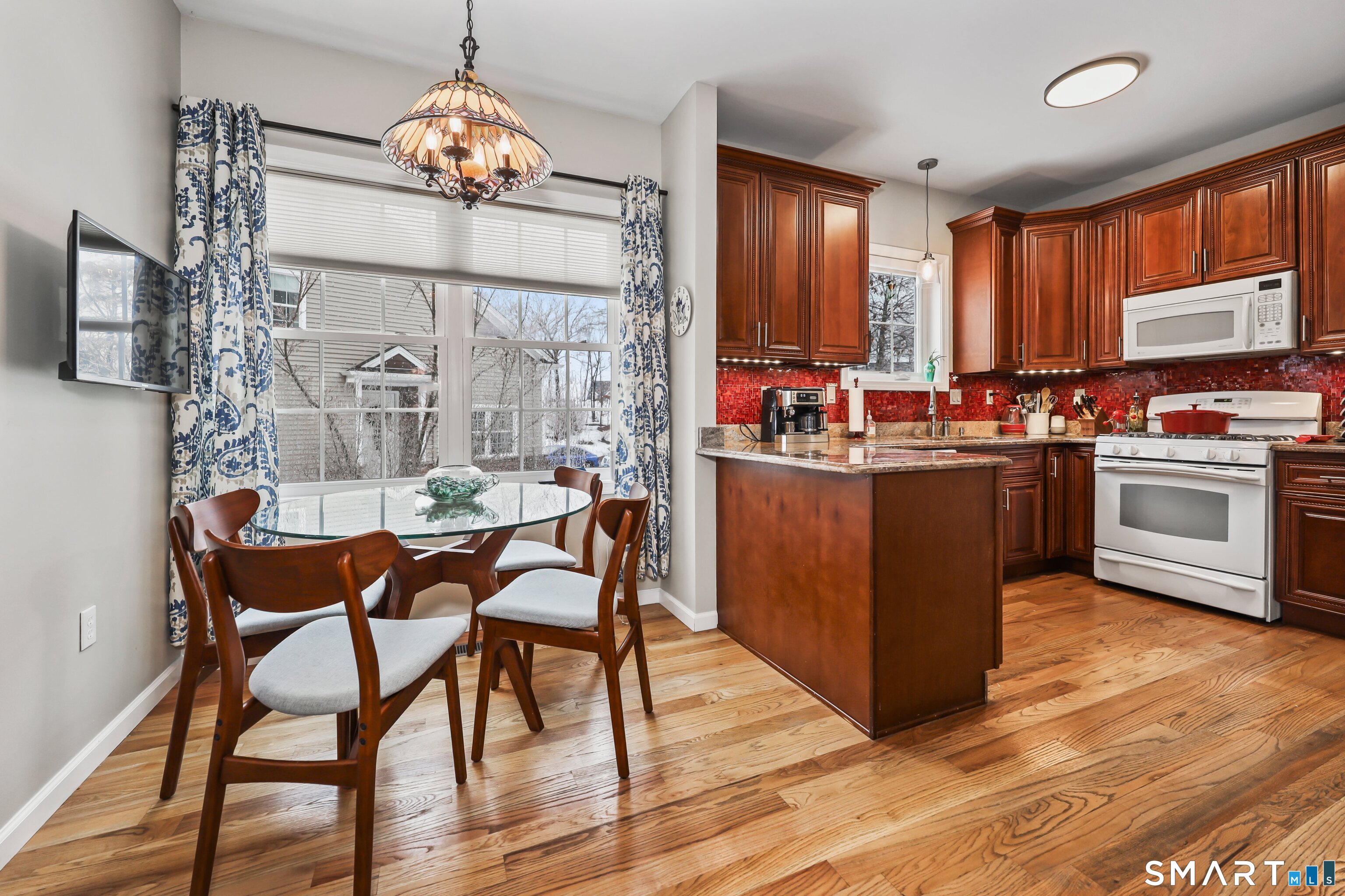 101 Turtlebrook Lane, Unit 101 Bristol, CT 06010 - Photo 5 of 48 a view of a dining room with furniture window and wooden floor