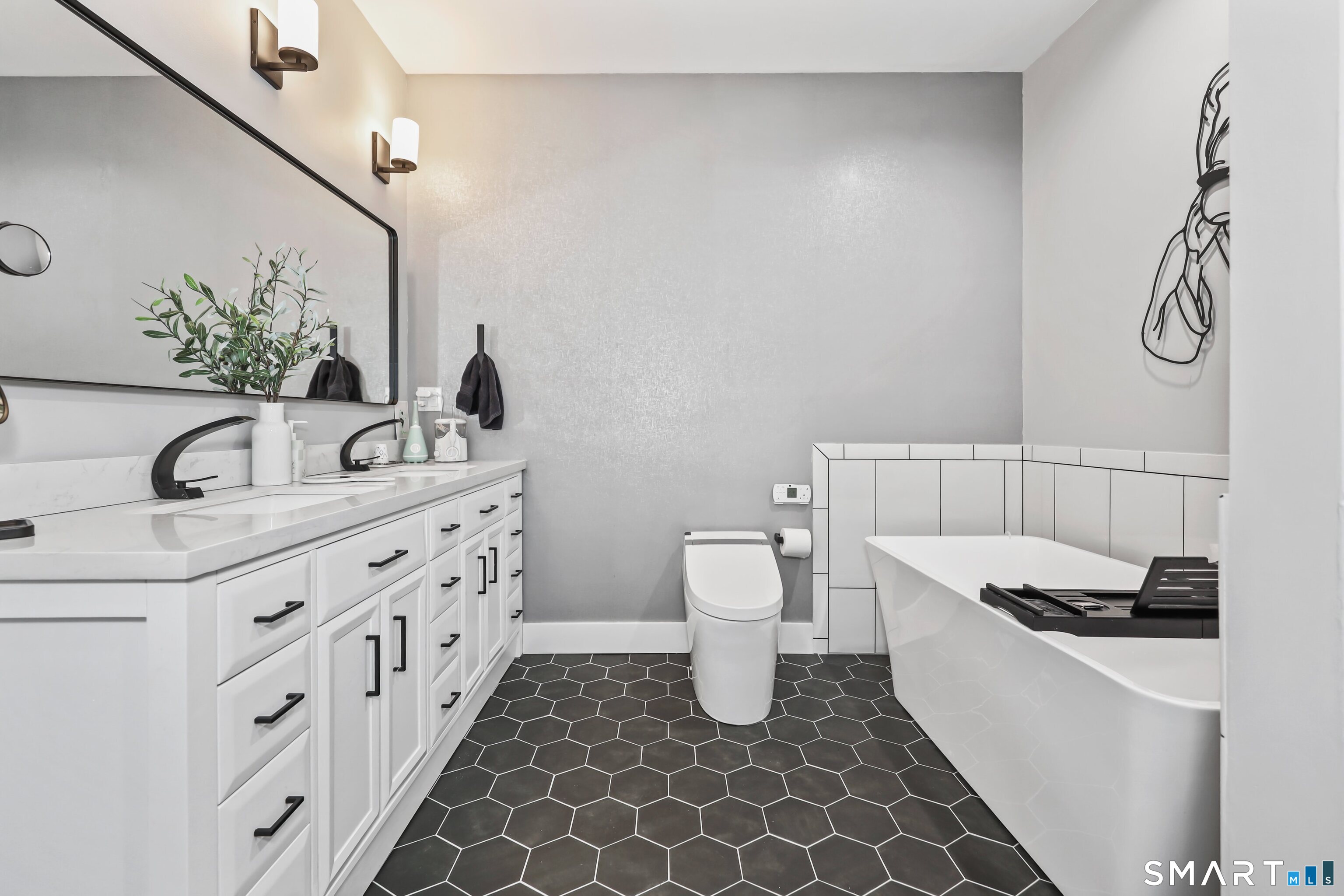 101 Turtlebrook Lane, Unit 101 Bristol, CT 06010 - Photo 8 of 48 a bathroom with a sink and a mirror