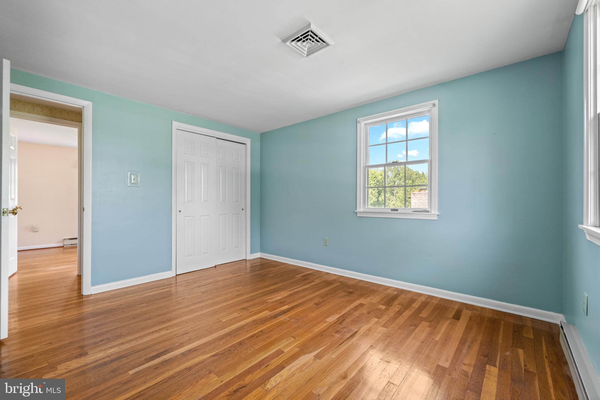 258 Monacy Road Coatesville, PA 19320 - Photo 41 of 54 a view of an empty room with wooden floor and a window