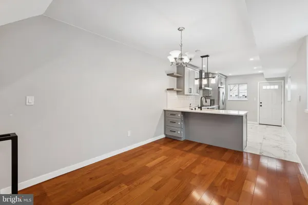 a view of a kitchen with a dishwasher and wooden floor
