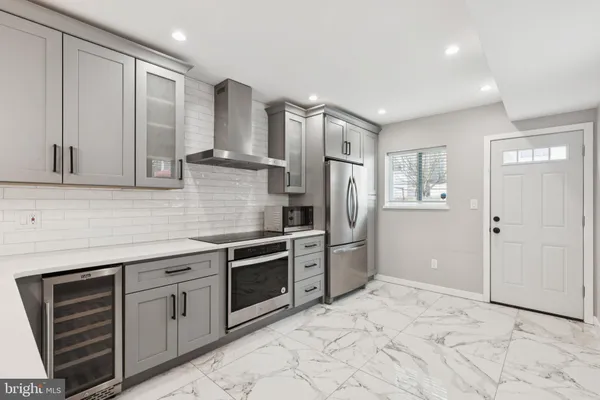 a kitchen with stainless steel appliances granite countertop a refrigerator and a sink