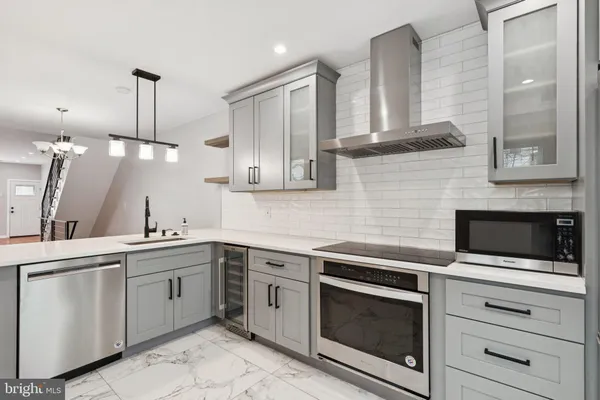 a kitchen with cabinets stainless steel appliances and a counter space