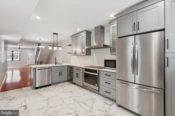 a kitchen with stainless steel appliances a refrigerator sink and microwave