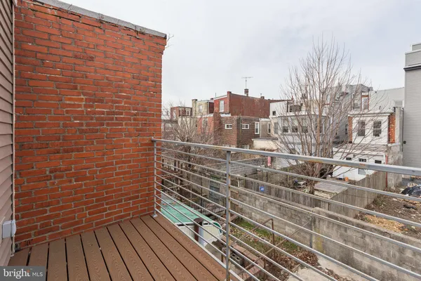 a view of a balcony with wooden floor and city view