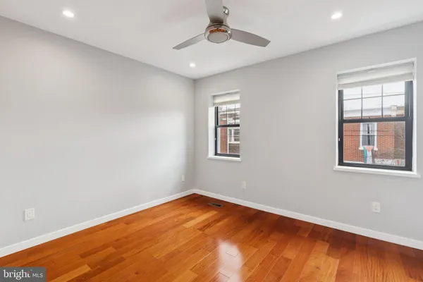 a view of an empty room with wooden floor